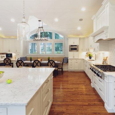 Sunlit white Kitchen with huge island, chandelier