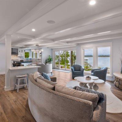 view across living room into kitchen with lake views outside